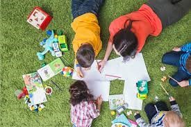 Children Coloring Pictures in the Grass